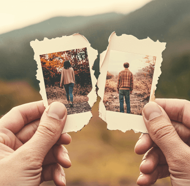 Torn photographs of a couple walking away, symbolizing separation and moving on after a divorce.