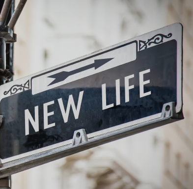 A close-up of a street sign reading 'New Life,' mounted on a lamp post